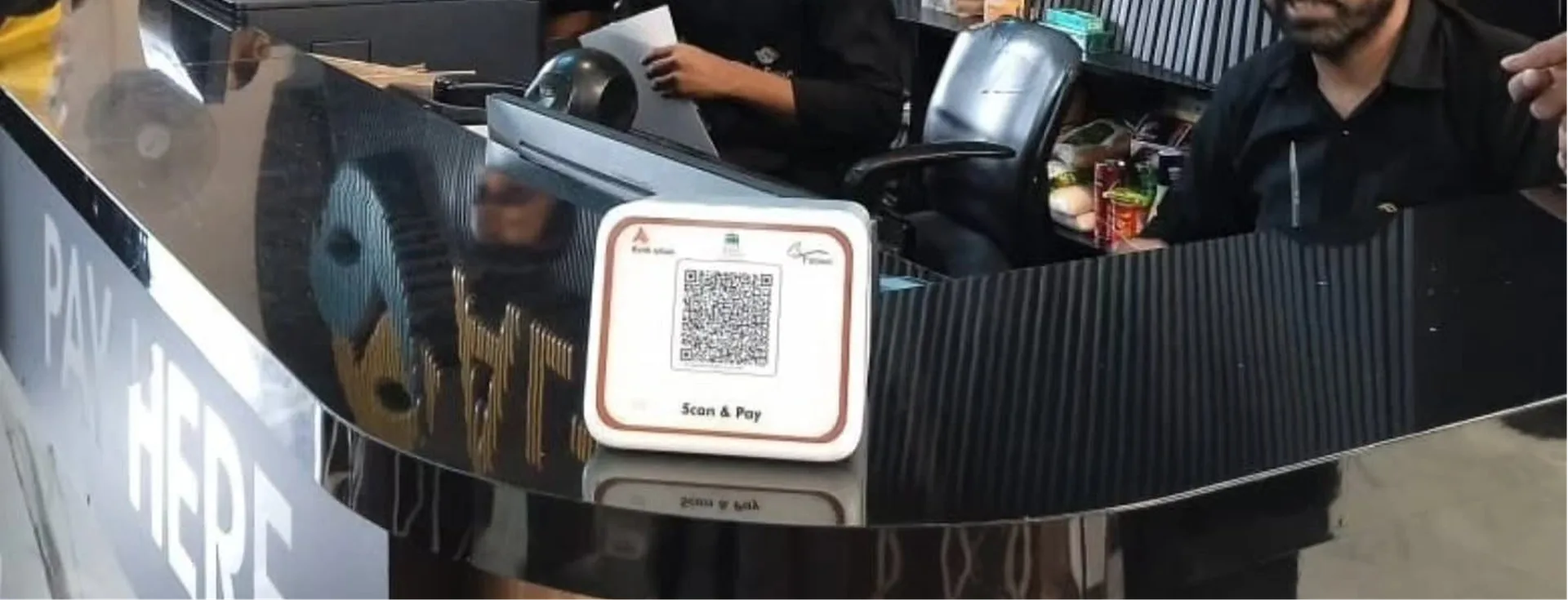 Bank Alfalah Scan & Pay QR payment card standing at a retail checkout counter