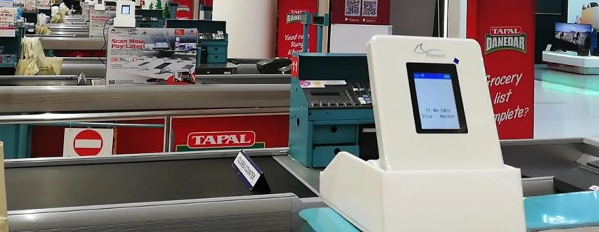 Finnect QR payment terminal at a supermarket checkout lane